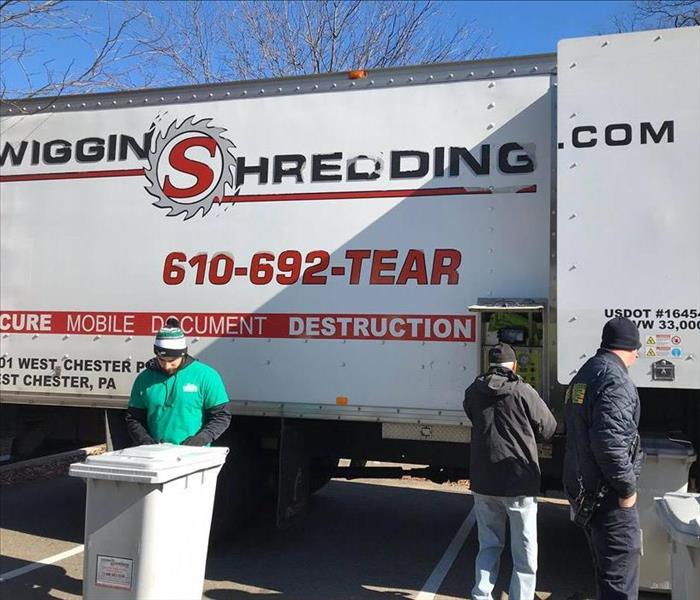 Volunteers in front of Wiggins Shredding truck