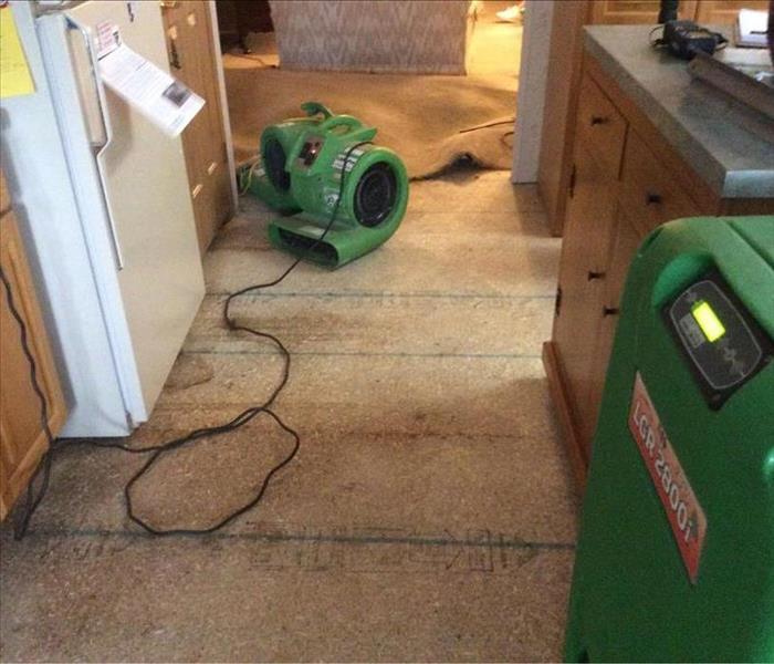 damaged floor with restoration equipment