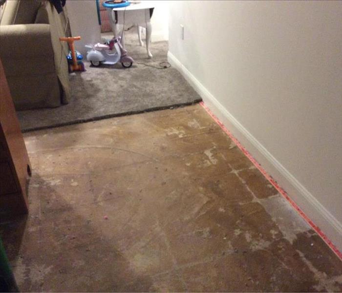 damaged floor after carpet removed with water damage